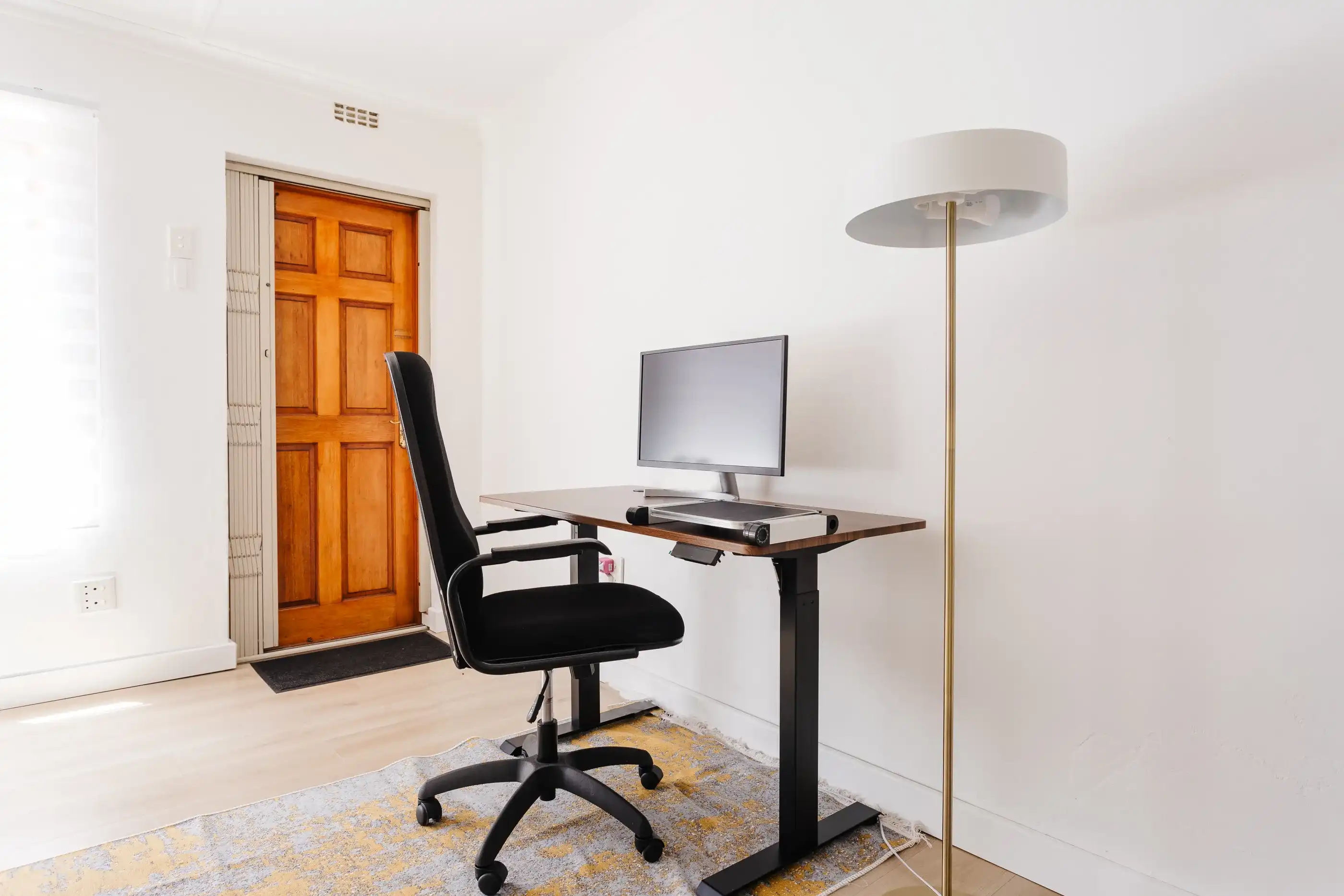 A modern desk setup with a large screen overlooking a serene garden.